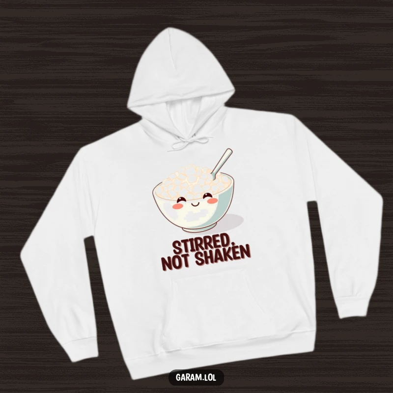 Funny hoodie featuring a cheerful bowl of rice with a wide smile, being gently stirred by a tiny spoon.
